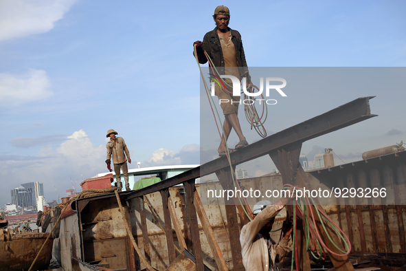 Myanmar workers work at a ship demolition site near Dala jetty in Yangon on December 7, 2022. 