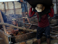 Myanmar workers work at a ship demolition site near Dala jetty in Yangon on December 7, 2022. (