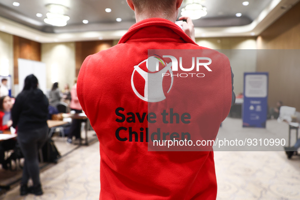 Save the Children logo is seen on a person's fleece during the job fair, organized mainly for Ukrainian refugees, in Krakow, Poland on Decem...