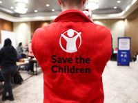 Save the Children logo is seen on a person's fleece during the job fair, organized mainly for Ukrainian refugees, in Krakow, Poland on Decem...