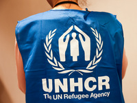 UNHCR logo is seen on a person's vest during the job fair, organized mainly for Ukrainian refugees, in Krakow, Poland on December 8, 2022. (