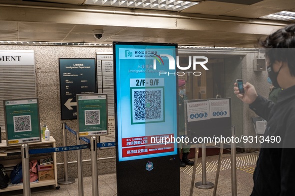 A man scanning a Leave Home Safe QR code display on a screen on December 13, 2022 in Hong Kong, China. The Hong Kong Government announced th...