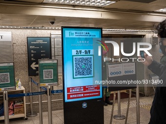 A man scanning a Leave Home Safe QR code display on a screen on December 13, 2022 in Hong Kong, China. The Hong Kong Government announced th...