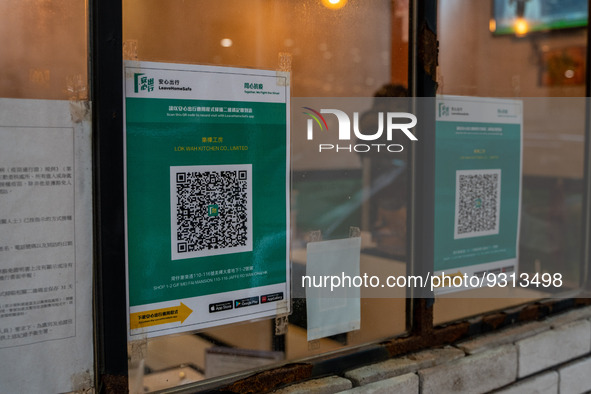 Leave Home Safe QR code placed on the window of a restaurant on December 13, 2022 in Hong Kong, China. The Hong Kong Government announced th...