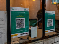 Leave Home Safe QR code placed on the window of a restaurant on December 13, 2022 in Hong Kong, China. The Hong Kong Government announced th...