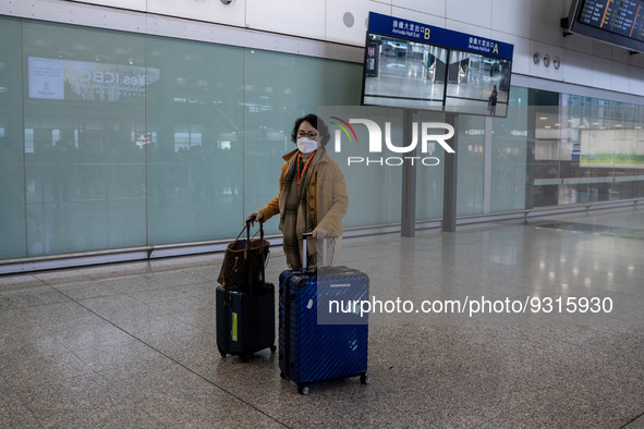 A women with luggages at the arrival hall inside Terminal 1 at Hong Kong International Airport on December 14, 2022 in Hong Kong, China. The...