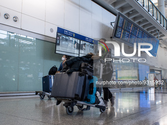 A woman pushing a luggage trolley at the arrival hall inside Terminal 1 at Hong Kong International Airport on December 14, 2022 in Hong Kong...