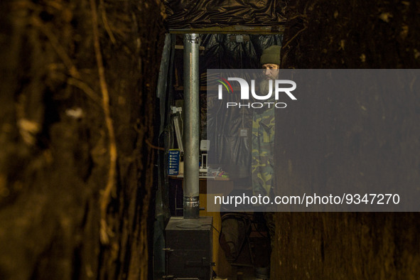 An ukrainian soldier warms in his underground shelter in the Zaporizhia region. Shelling from russian positions are constant, so, they have...