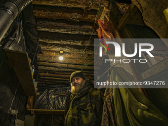 An ukrainian soldier waits in the underground base of his unit during a russian shelling in the Zaporizhia region. (