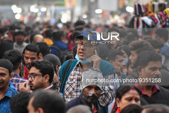 A man is seen improperly wearing a mask at a crowded place in Kolkata ,India , on 22 December 2022 . Indian health administration has issued...