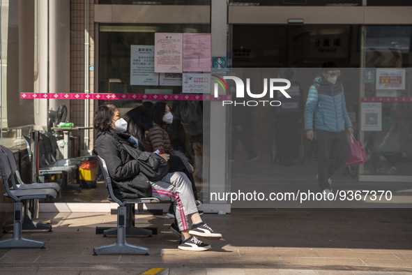 People sitting at the entrance for the emergency room at Kiang Wu Hospital on December 29, 2022 in Macau, China. 