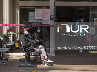 People sitting at the entrance for the emergency room at Kiang Wu Hospital on December 29, 2022 in Macau, China. (