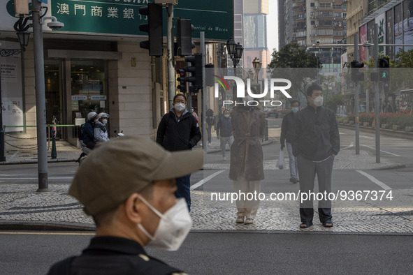 Pedestrian wearing face masks waiting to cross the street on December 29, 2022 in Macau, China. 