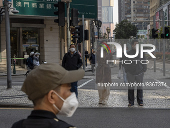 Pedestrian wearing face masks waiting to cross the street on December 29, 2022 in Macau, China. (