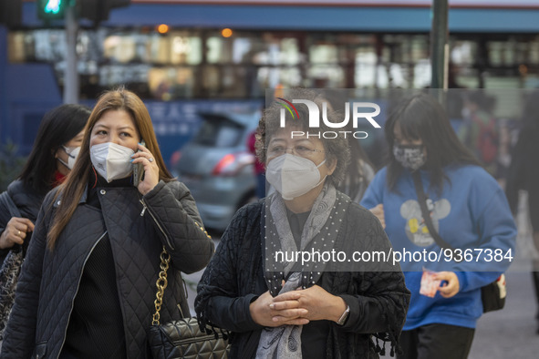 Pedestrian wearing face masks while walking in the street on December 29, 2022 in Macau, China. 