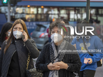 Pedestrian wearing face masks while walking in the street on December 29, 2022 in Macau, China. (