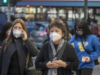 Pedestrian wearing face masks while walking in the street on December 29, 2022 in Macau, China. (