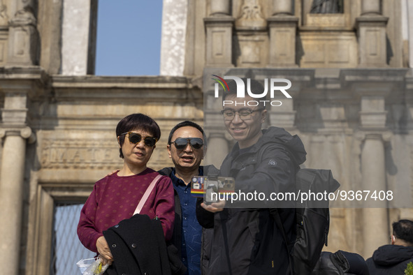 People talking a selfie with the Ruins of St. Paul's on December 29, 2022 in Macau, China. 