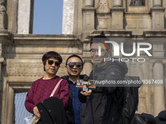 People talking a selfie with the Ruins of St. Paul's on December 29, 2022 in Macau, China. (