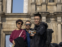 People talking a selfie with the Ruins of St. Paul's on December 29, 2022 in Macau, China. (