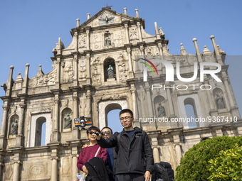 People talking a selfie with the Ruins of St. Paul's on December 29, 2022 in Macau, China. (