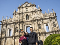 People talking a selfie with the Ruins of St. Paul's on December 29, 2022 in Macau, China. (