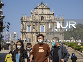 People wearing Face Mask walks pass the Ruins of St. Paul's on December 29, 2022 in Macau, China. (