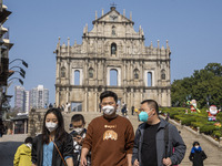 People wearing Face Mask walks pass the Ruins of St. Paul's on December 29, 2022 in Macau, China. (