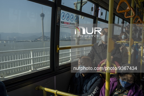 Commuters wearing face masks while riding on a bus on December 29, 2022 in Macau, China. 