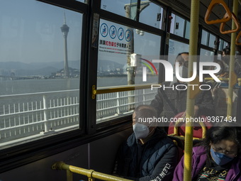 Commuters wearing face masks while riding on a bus on December 29, 2022 in Macau, China. (