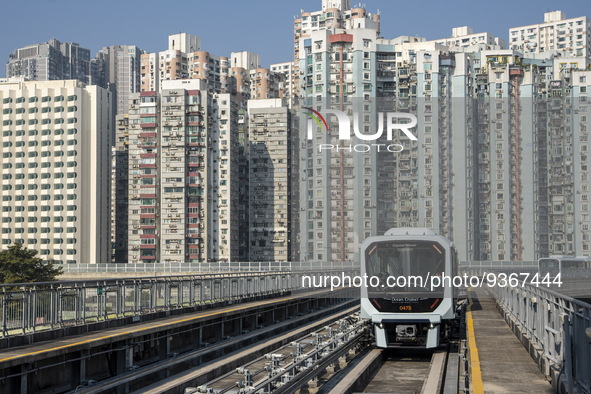 A train of the Macao Light Rapid Transit in front of residential housing on December 29, 2022 in Macau, China. 