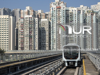 A train of the Macao Light Rapid Transit in front of residential housing on December 29, 2022 in Macau, China. (