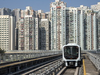 A train of the Macao Light Rapid Transit in front of residential housing on December 29, 2022 in Macau, China. (