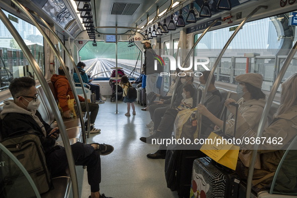 Commuters wearing face masks riding on the Macao Light Rapid Transit on December 29, 2022 in Macau, China. 