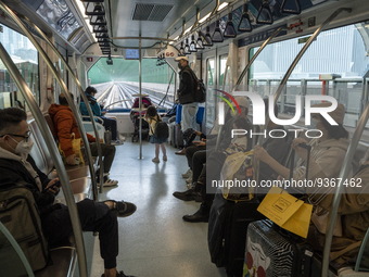 Commuters wearing face masks riding on the Macao Light Rapid Transit on December 29, 2022 in Macau, China. (