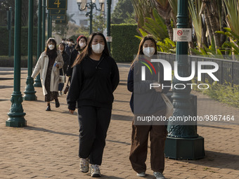 People wearing face masks walking in the street on December 29, 2022 in Macau, China. (