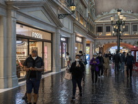 Shoppers wearing face masks inside The Grand Canal Shoppes on December 29, 2022 in Macau, China. (