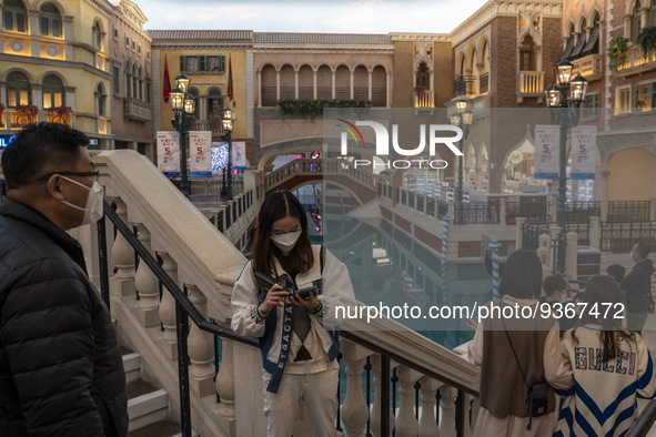 People wearing face mask inside The Grand Canal Shoppes on December 29, 2022 in Macau, China. 