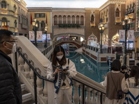 People wearing face mask inside The Grand Canal Shoppes on December 29, 2022 in Macau, China. (