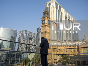 A man standing front of hotels , resorts and Casinos on the Cotai Strop on December 29, 2022 in Macau, China. (