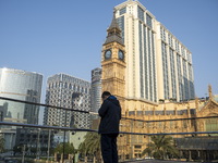 A man standing front of hotels , resorts and Casinos on the Cotai Strop on December 29, 2022 in Macau, China. (