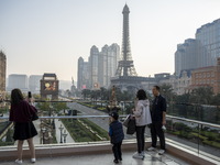 People looking at the Hotels, Resorts and Casinos on the Cotai Strip on December 29, 2022 in Macau, China. (