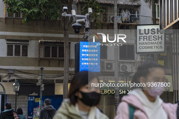 People wearing face masks in front of a dozen of CCTV Camera on December 29, 2022 in Macau, China. 