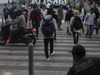 Peoples crossing the road as they visiting the Kota Tua Jakarta (Jakarta Old Town) tourism area during the holiday season, in Jakarta on Dec...