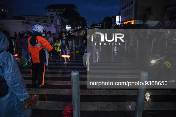 Peoples crossing the road as they visiting the Kota Tua Jakarta (Jakarta Old Town) tourism area during the holiday season, in Jakarta on Dec...