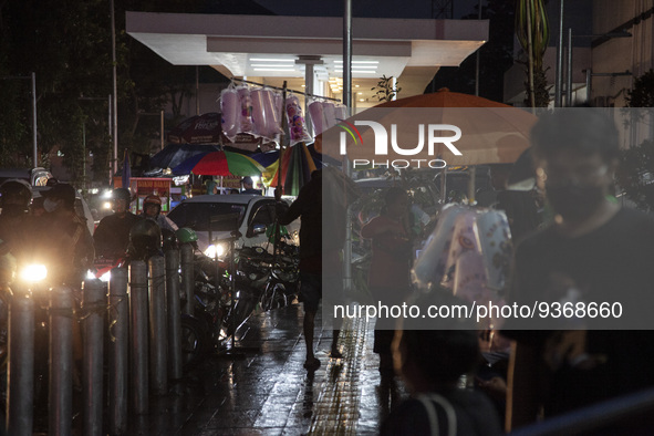 A cotton candy seller walks on pedestrian at the the Kota Tua Jakarta (Jakarta Old Town) tourism area during the holiday season, in Jakarta...