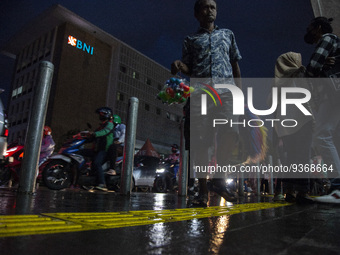 A toys seller walks on pedestrian at the the Kota Tua Jakarta (Jakarta Old Town) tourism area during the holiday season, in Jakarta on Decem...