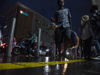 A toys seller walks on pedestrian at the the Kota Tua Jakarta (Jakarta Old Town) tourism area during the holiday season, in Jakarta on Decem...