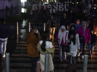 Peoples crossing the road as they visiting the Kota Tua Jakarta (Jakarta Old Town) tourism area during the holiday season, in Jakarta on Dec...