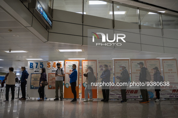 People lining up next to signs for the Sinovac CoronaVac Inactivated Vaccine by China Biotechnology company, Sinovac Biotech Ltd.,at a Covid...